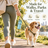 Portable dog pooper scooper hanging from a wrist strap during a park walk with a dog, designed for daily walks, dog parks, and travel