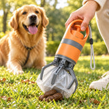 Orange portable dog pooper scooper with six-claw pickup mechanism and waste bag shown collecting dog waste during an outdoor walk